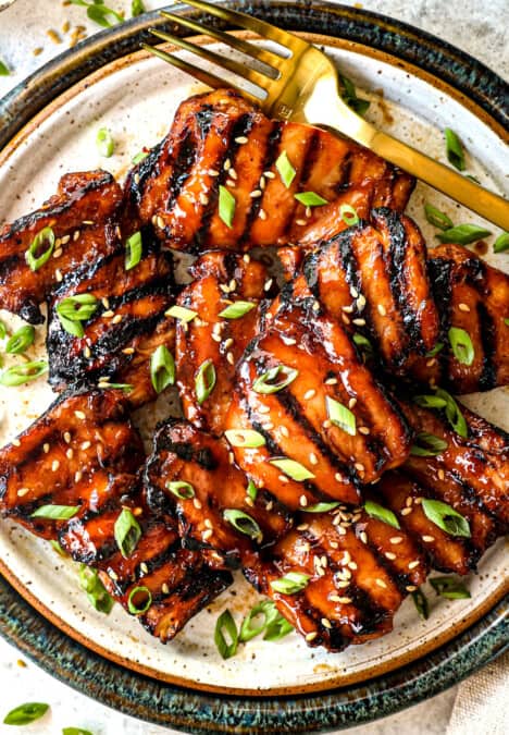top view of grilled chicken thighs on a platter