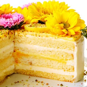 layer cake sliced open showing the layers of frosting, cake and lemon curd