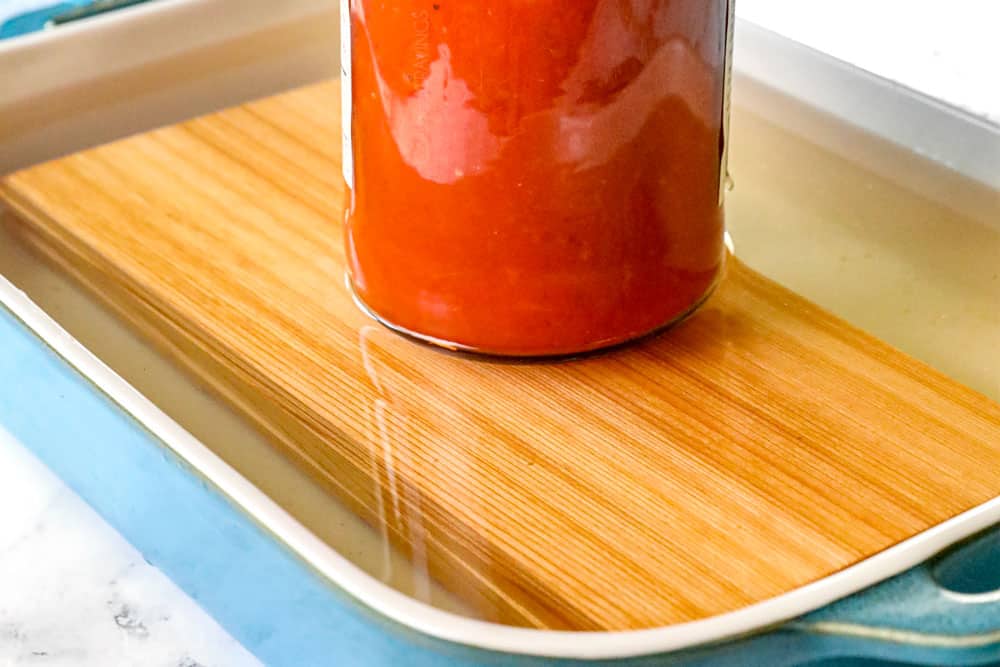 showing how to make cedar plank salmon recipe by soaking cedar planks in water