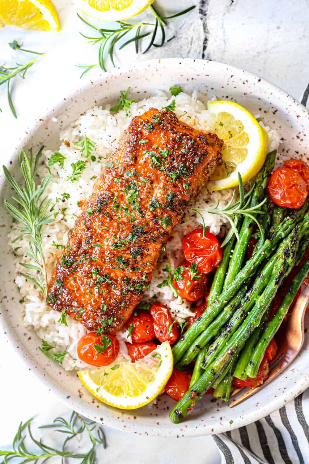 top view of how to serve cedar planked salmon recipe with rice, asparagus and tomatoes in a bowl