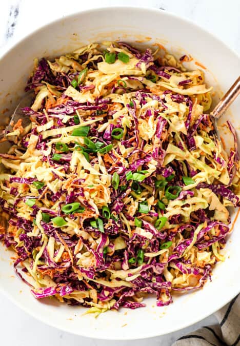 top view of coleslaw recipe by showing coleslaw ingredients of cabbage, carrots and green onions