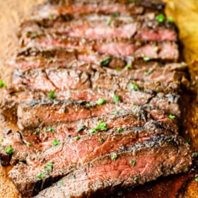 skirt steak recipe marinated and grilled, then sliced across the grain on a cutting board