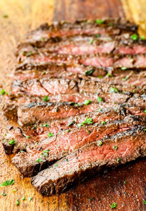 skirt steak recipe marinated and grilled, then sliced across the grain on a cutting board