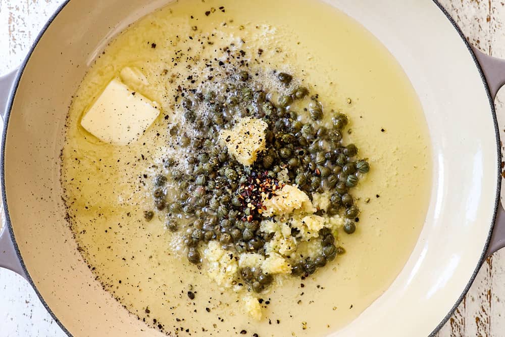 showing how to make lemon pasta (pasta al limone) by sautéing garlic, red pepper, ground pepper and capers in lemon and butter