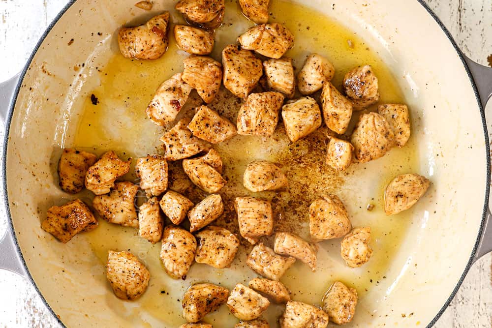 showing how to make Chicken Broccoli Alfredo recipe by sautéing chicken in a pan