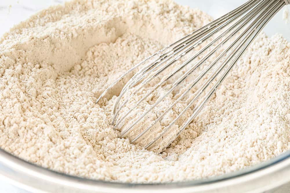 showing how to make pumpkin snickerdoodles by whisking together flour, baking soda, baking powder and cream of tartar