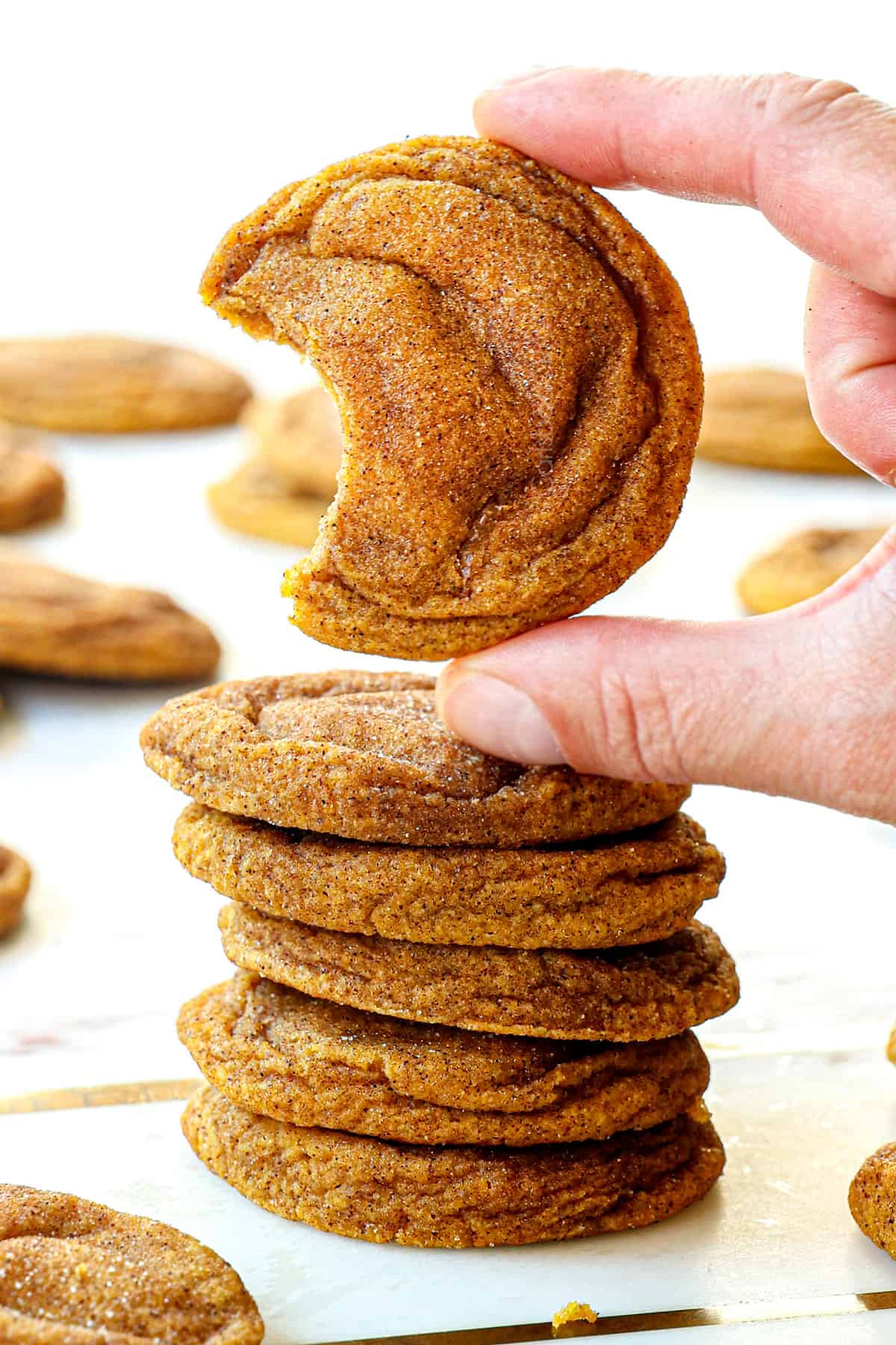 picking up a pumpkin snickerdoodle cookie showing how chewy they are