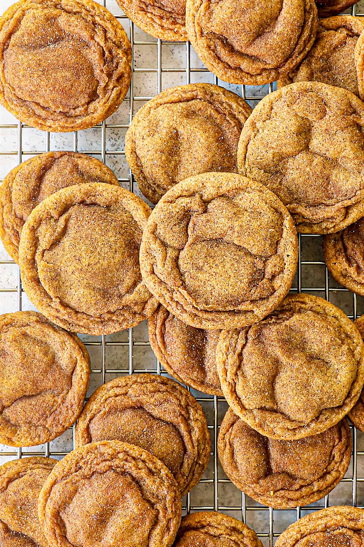 top view showing how to make pumpkin snickerdoodle cookies by cooling on a baking rack