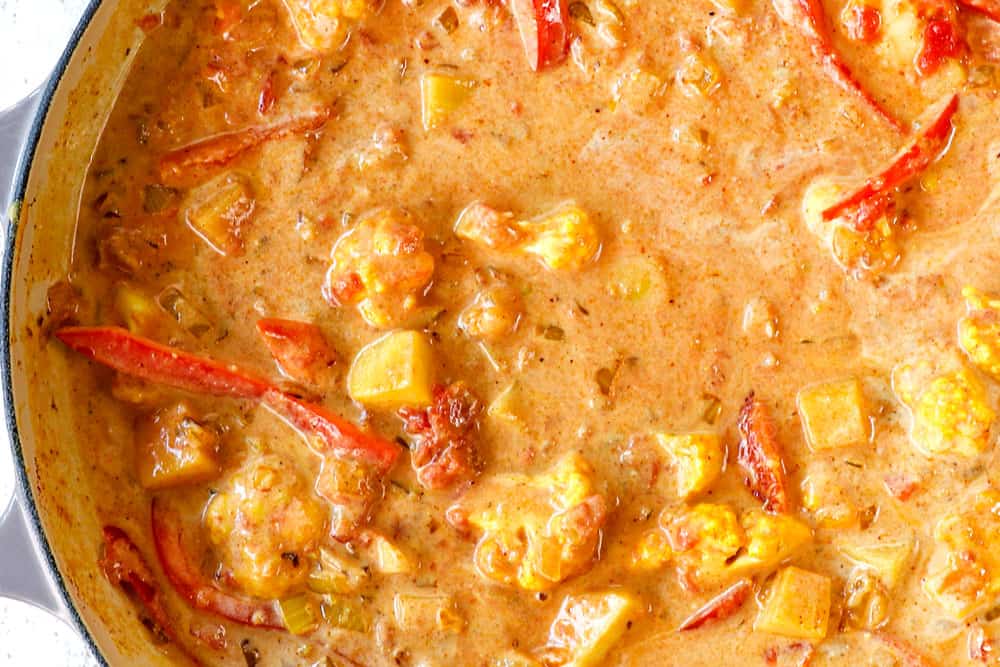 showing how to make coconut shrimp curry recipe by simmering the shrimp curry