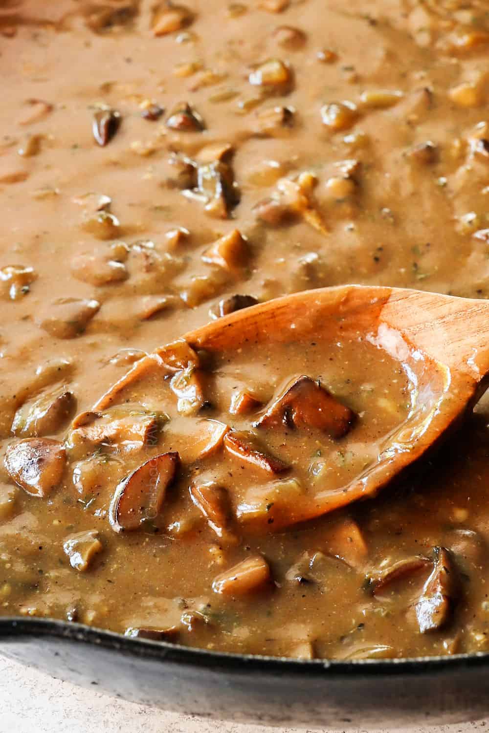 showing how to make loco moco recipe by by simmering gravy until thickened