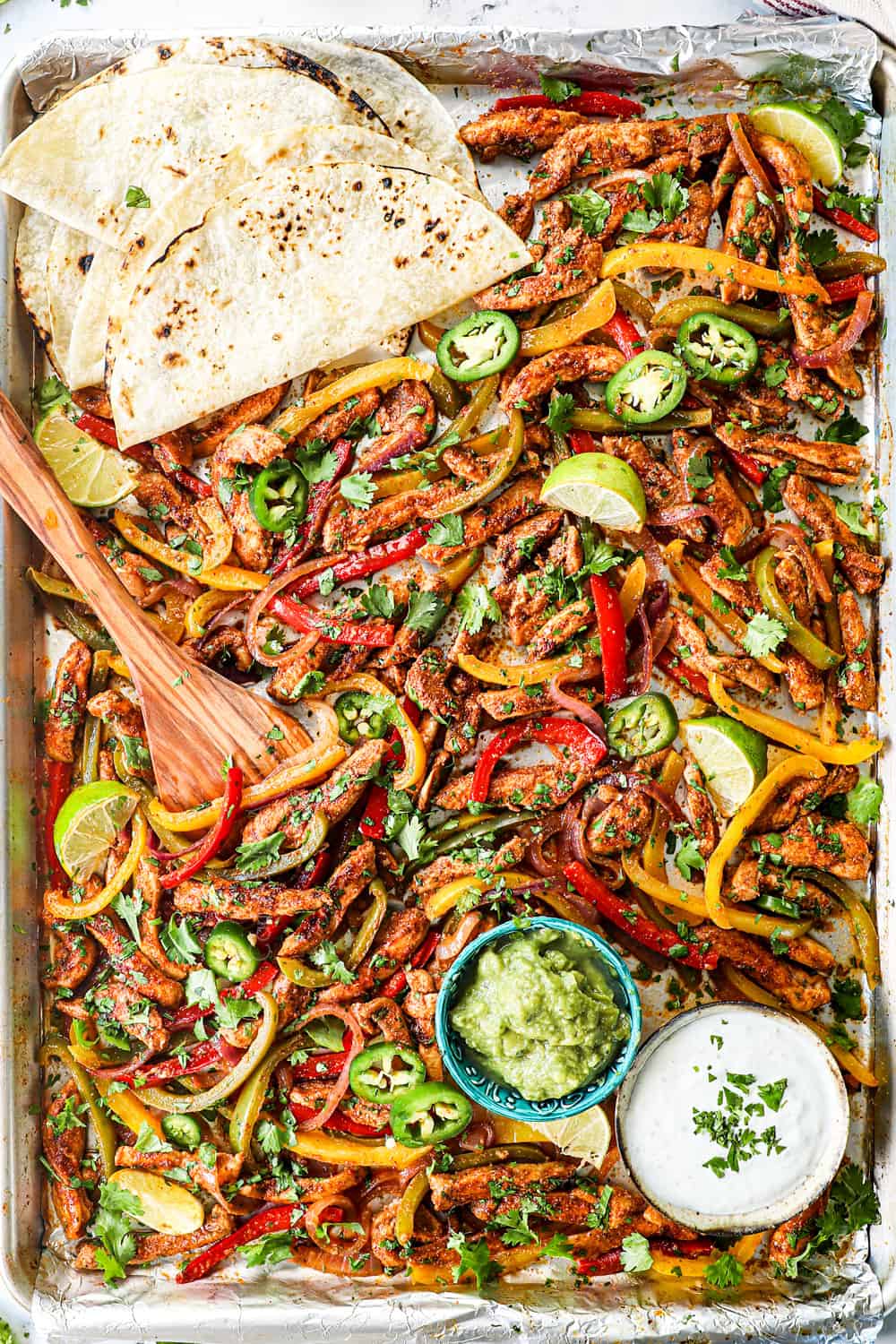 top view of sheet pan chicken fajitas coming out of the oven