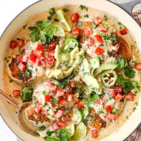 top view of smothered chicken recipe garnished with tomatoes