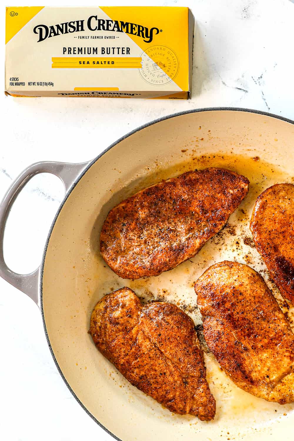 top view showing how to make smothered chicken recipe by searing the chicken in butter
