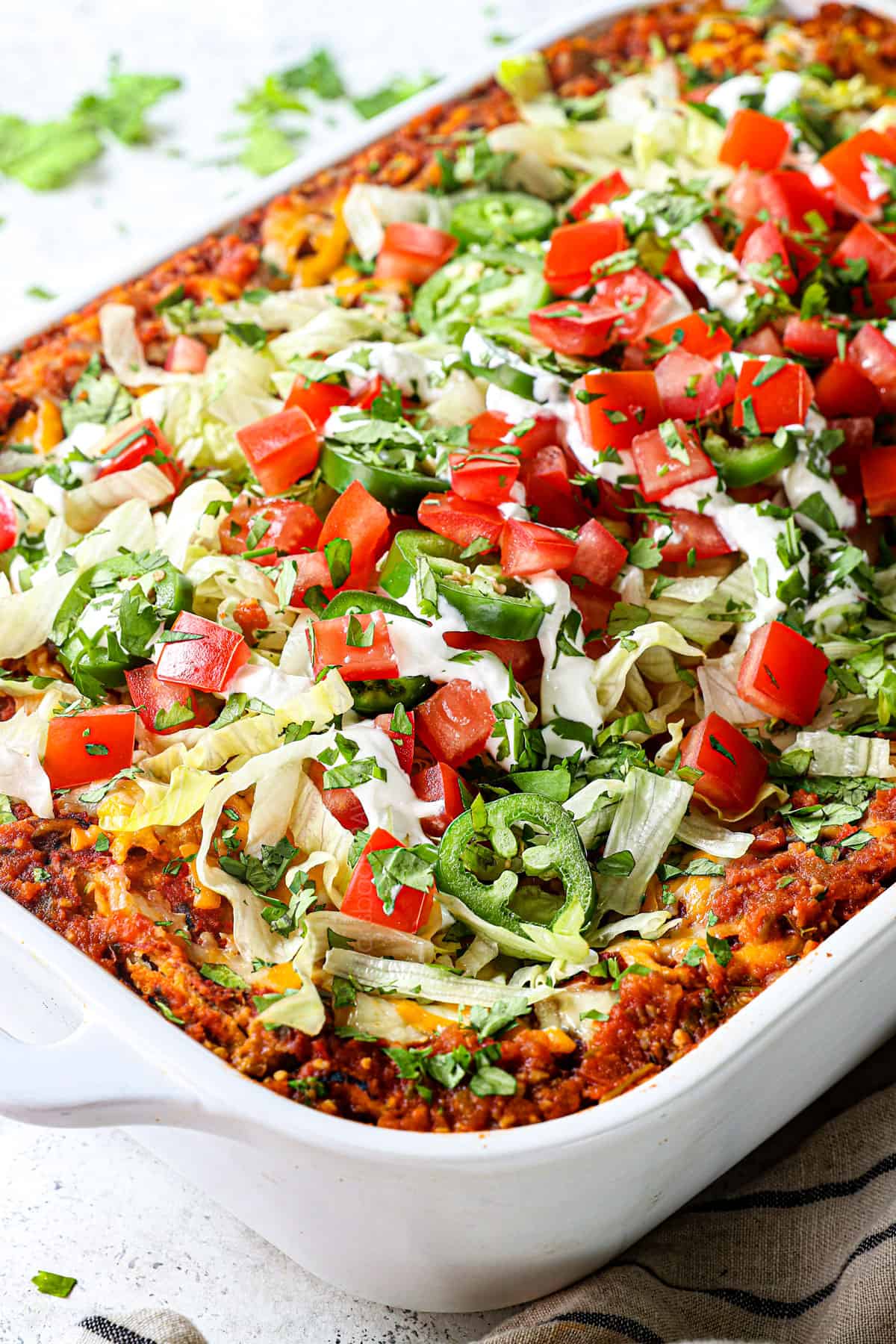 side view of taco lasagna casserole recipe layered with ground beef, tortillas, cheese and salsa