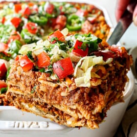 up close of a serving a slice of taco lasagna showing all the layers