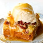 showing how to serve pumpkin dump cake by adding to a plate with whipped cream