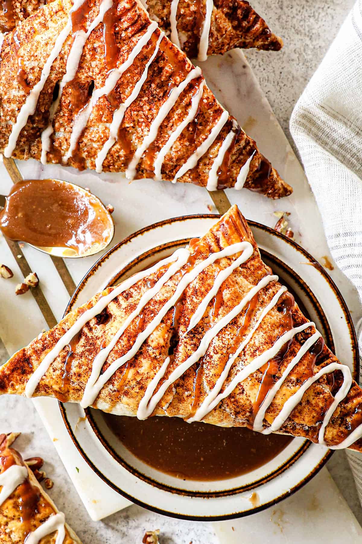 up close of apple turnover drizzled with vanilla glaze