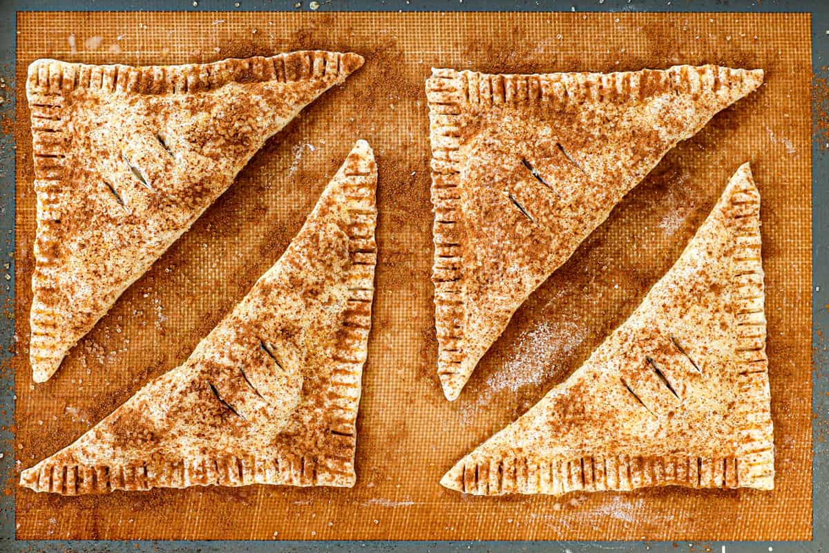 showing how to make apple turnover recipe by baking puff pastries on a nonstick mat until golden and puffy