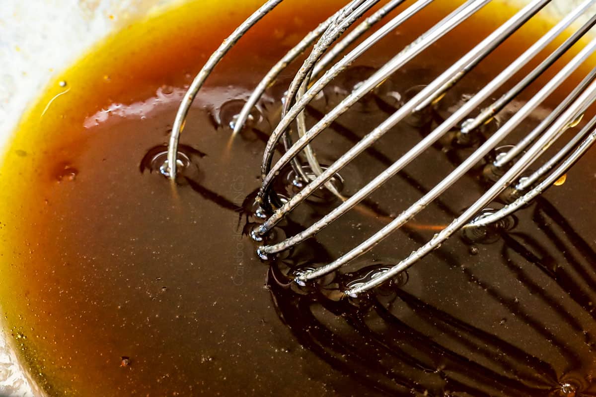 showing how to make Bacon Wrapped Brussels Sprouts by whisking together maple glaze ingredients