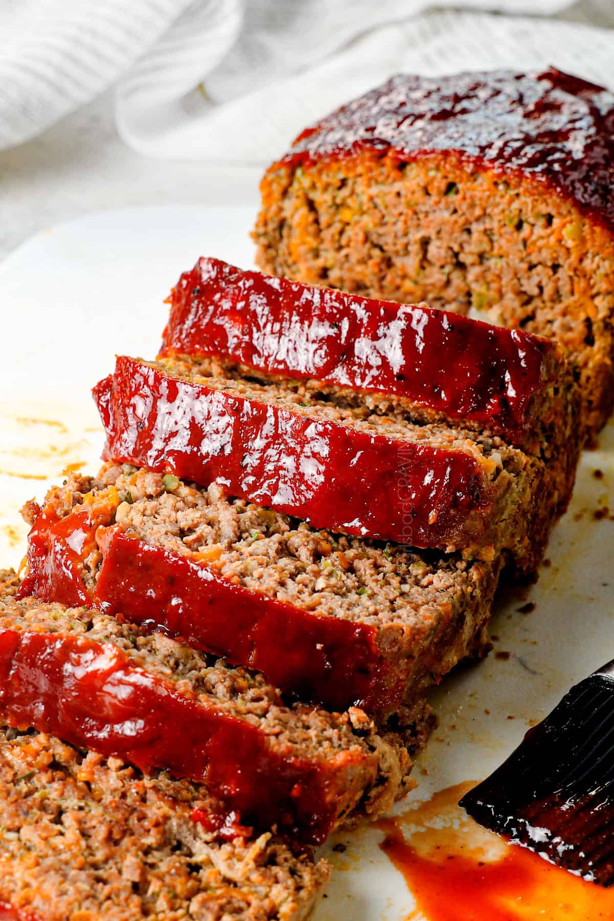 best meatloaf recipe sliced on a cutting board showing how juicy it is