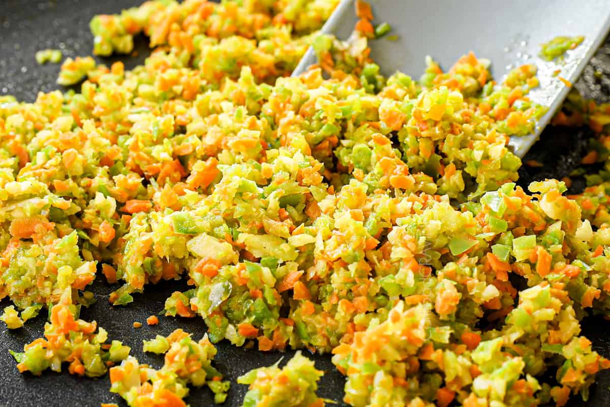 showing how to make easy meatloaf by sautéing the vegetables in a pan to soften