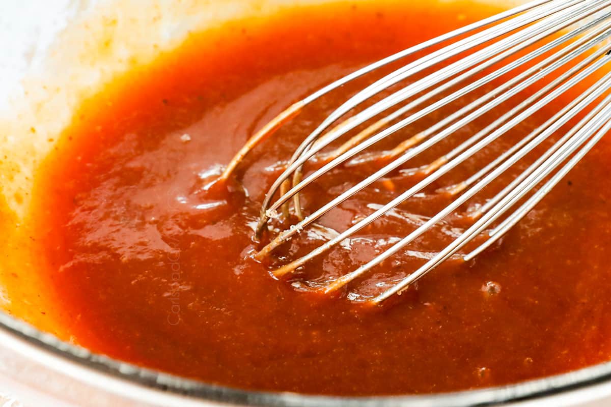 showing how to make best meatloaf by whisking the meatloaf glaze ingredients together