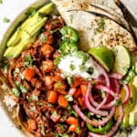 showing how to serve chicken mole by serving with pic de gallo, rice and warm flour tortillas in a bowl