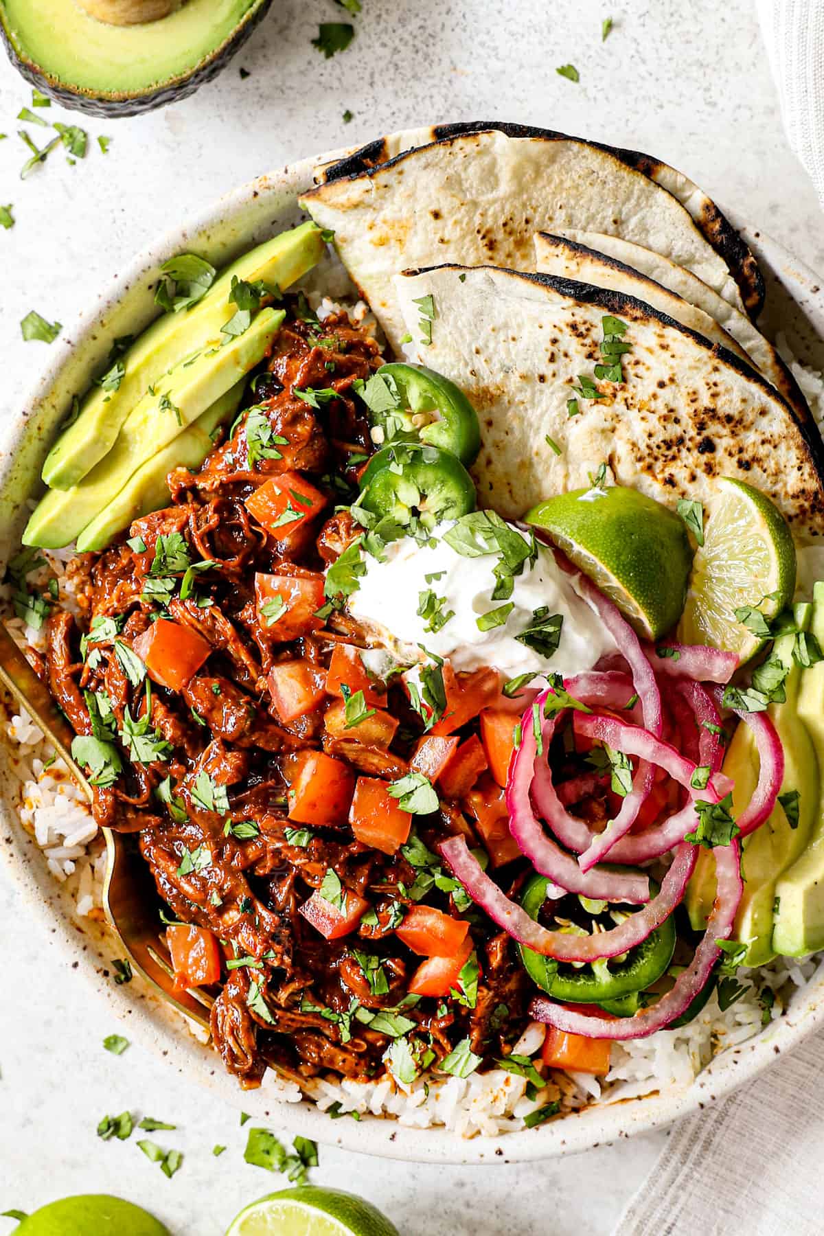 showing how to serve chicken mole by serving with pic de gallo, rice and warm flour tortillas in a bowl