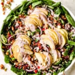 up close of serving pear salad with gorgonzola in a white bowl