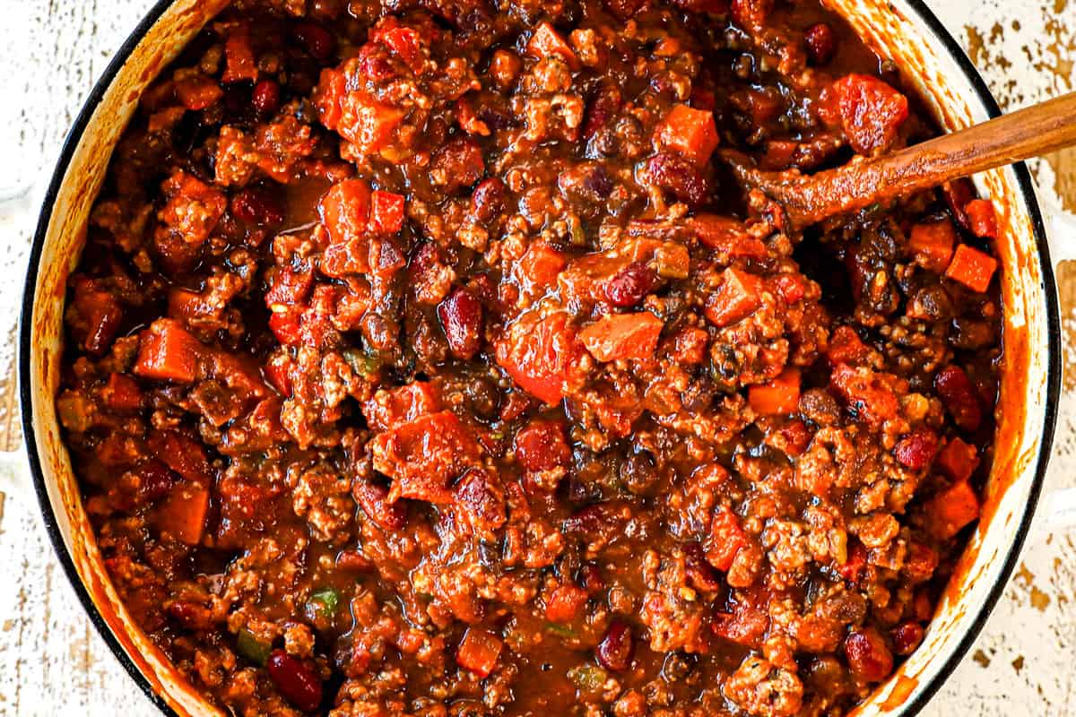 showing how to make pumpkin chili recipe by simmering the chili until thickened