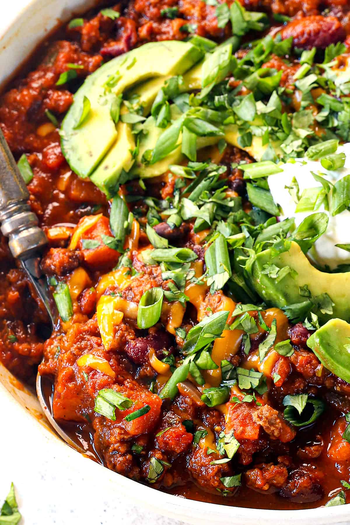 showing who rich and hearty the pumpkin chili recipe is by scooping it up with a spoon