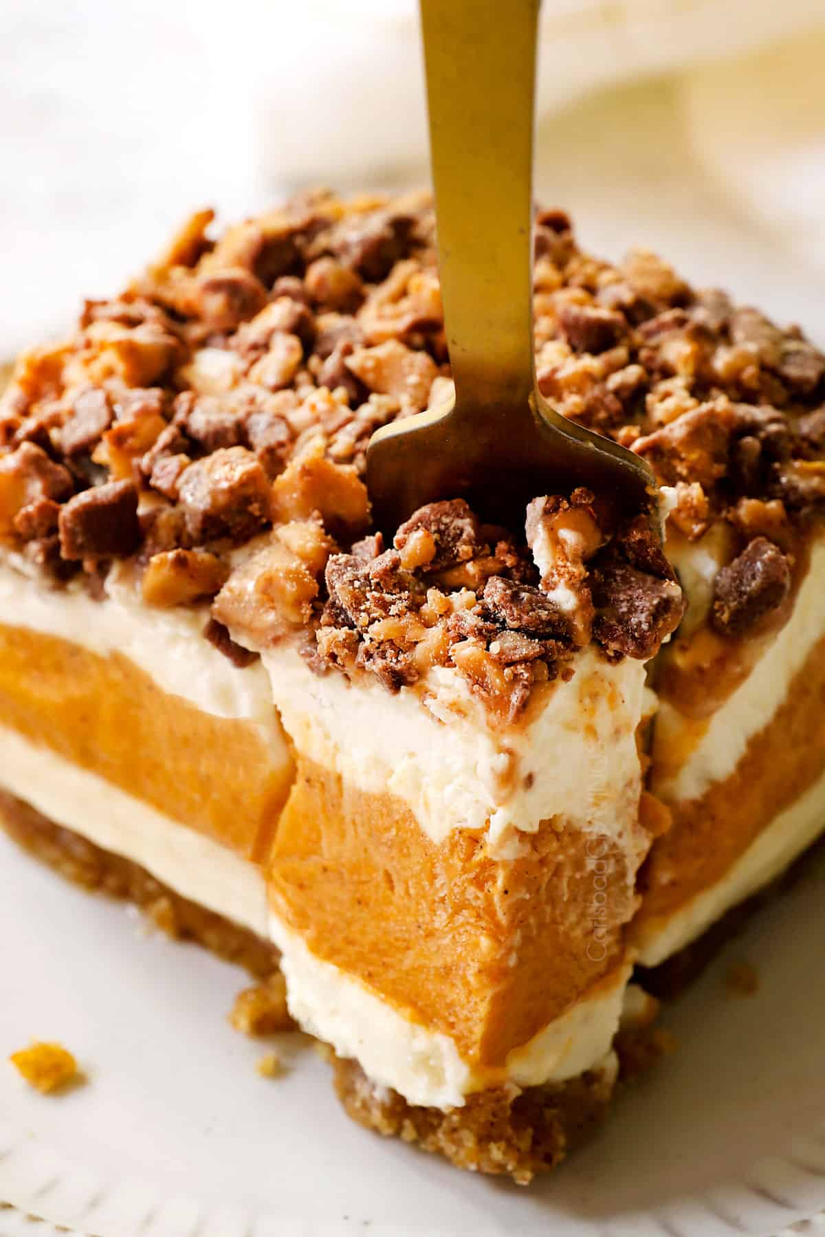 a fork taking a bite out of pumpkin delight (pumpkin lush)