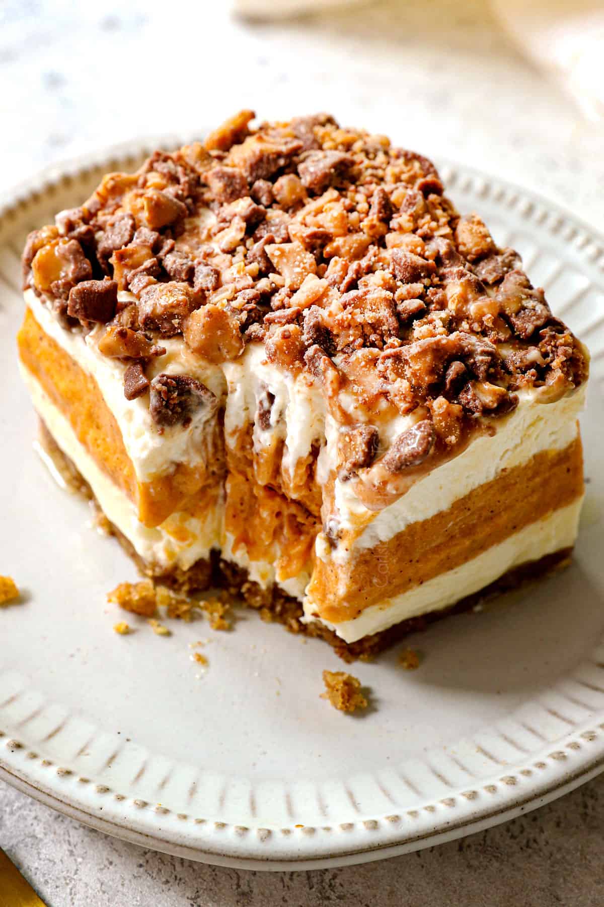 a slice of pumpkin delight (pumpkin lush) with a bite taken out