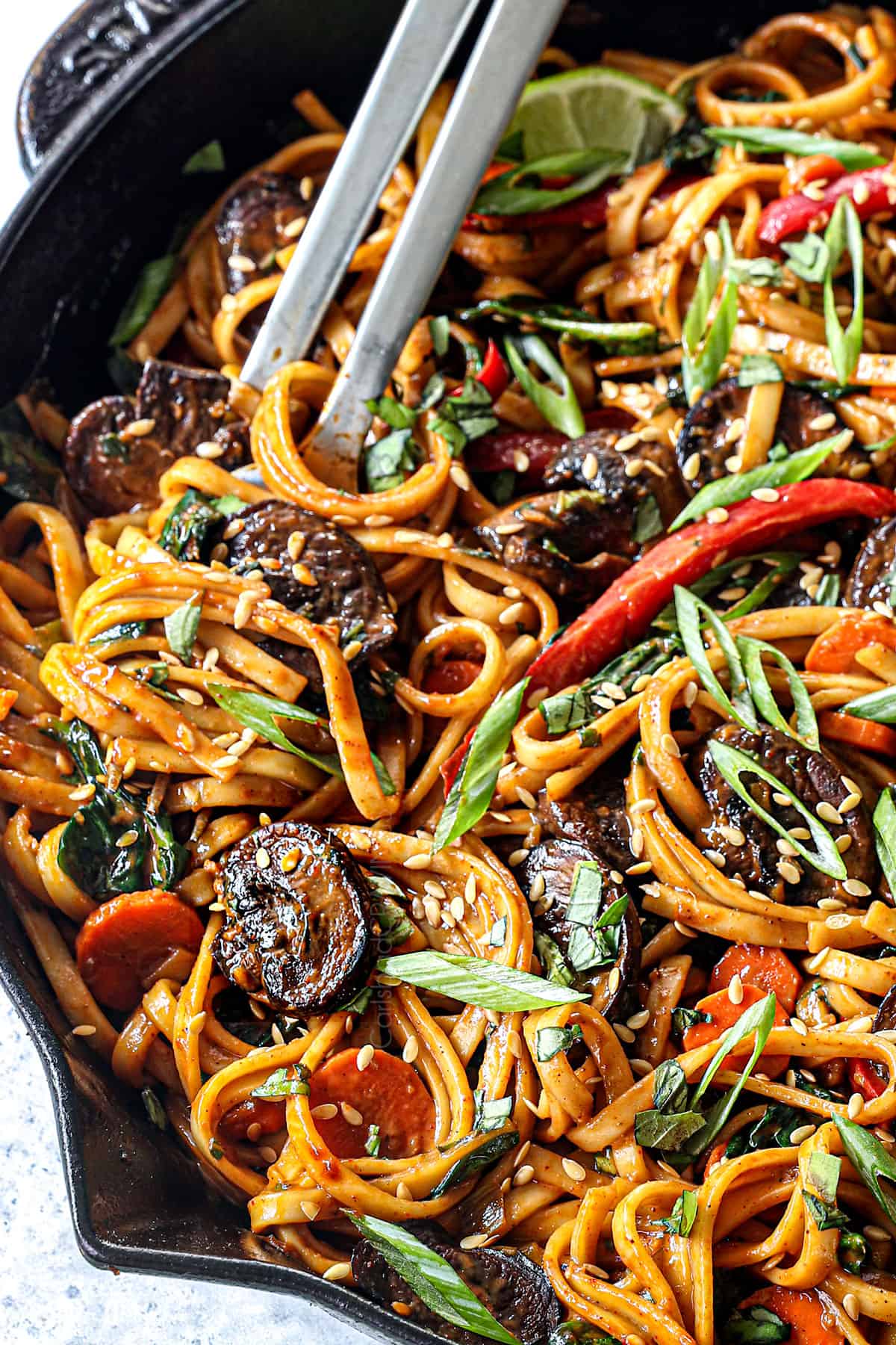side up close view of udon noodles stir fried with vegetables showing their chewy texture