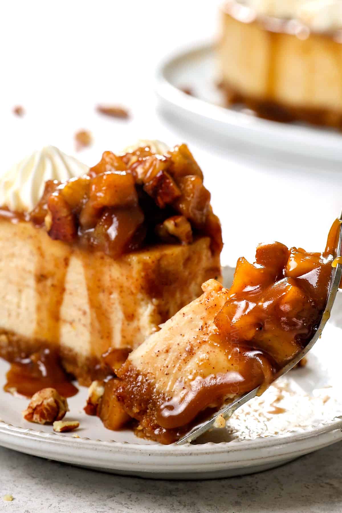 a bite of caramel apple cheesecake with tender apples