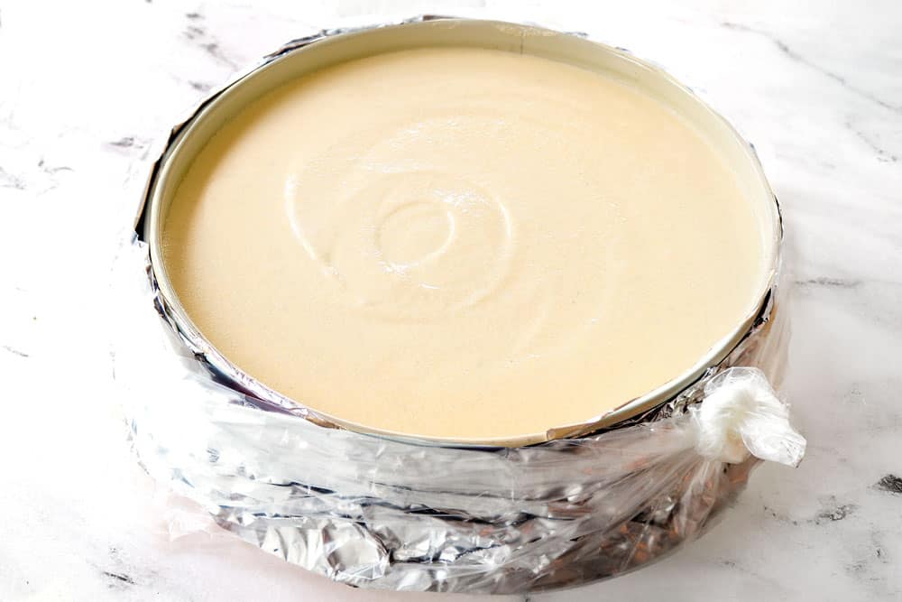 showing how to make Caramel Apple Cheesecake by waterproofing the pan by wrapping in a slow cooker liner