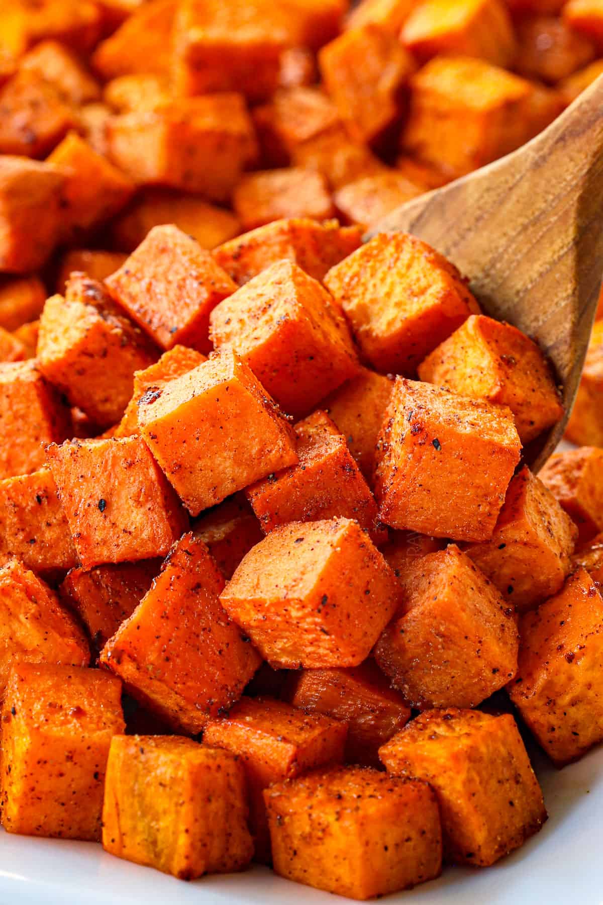 showing how to make sweet potato salad by roasting sweet potatoes with spices