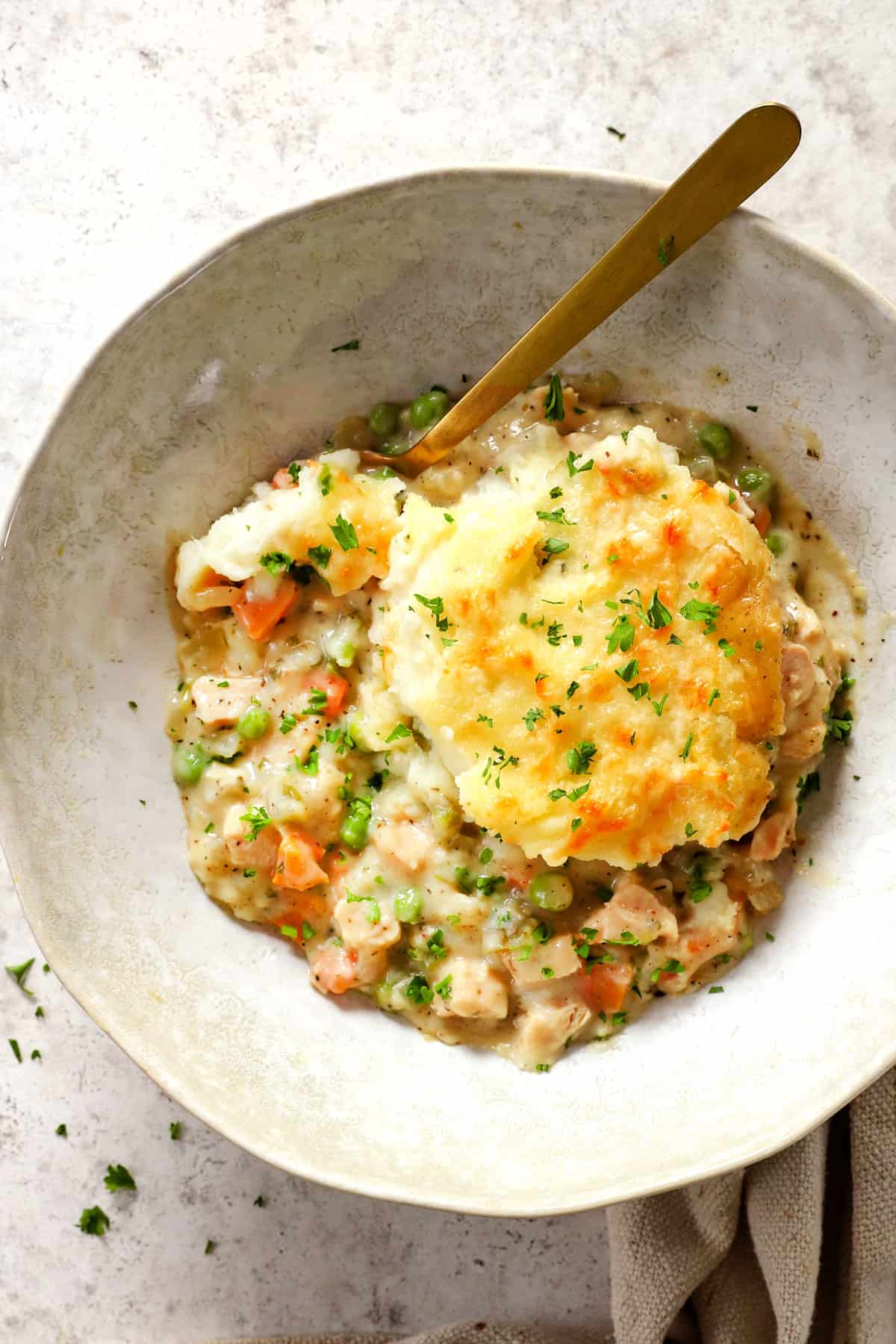 top view of serving turkey shepherd's pie garnished with parsley