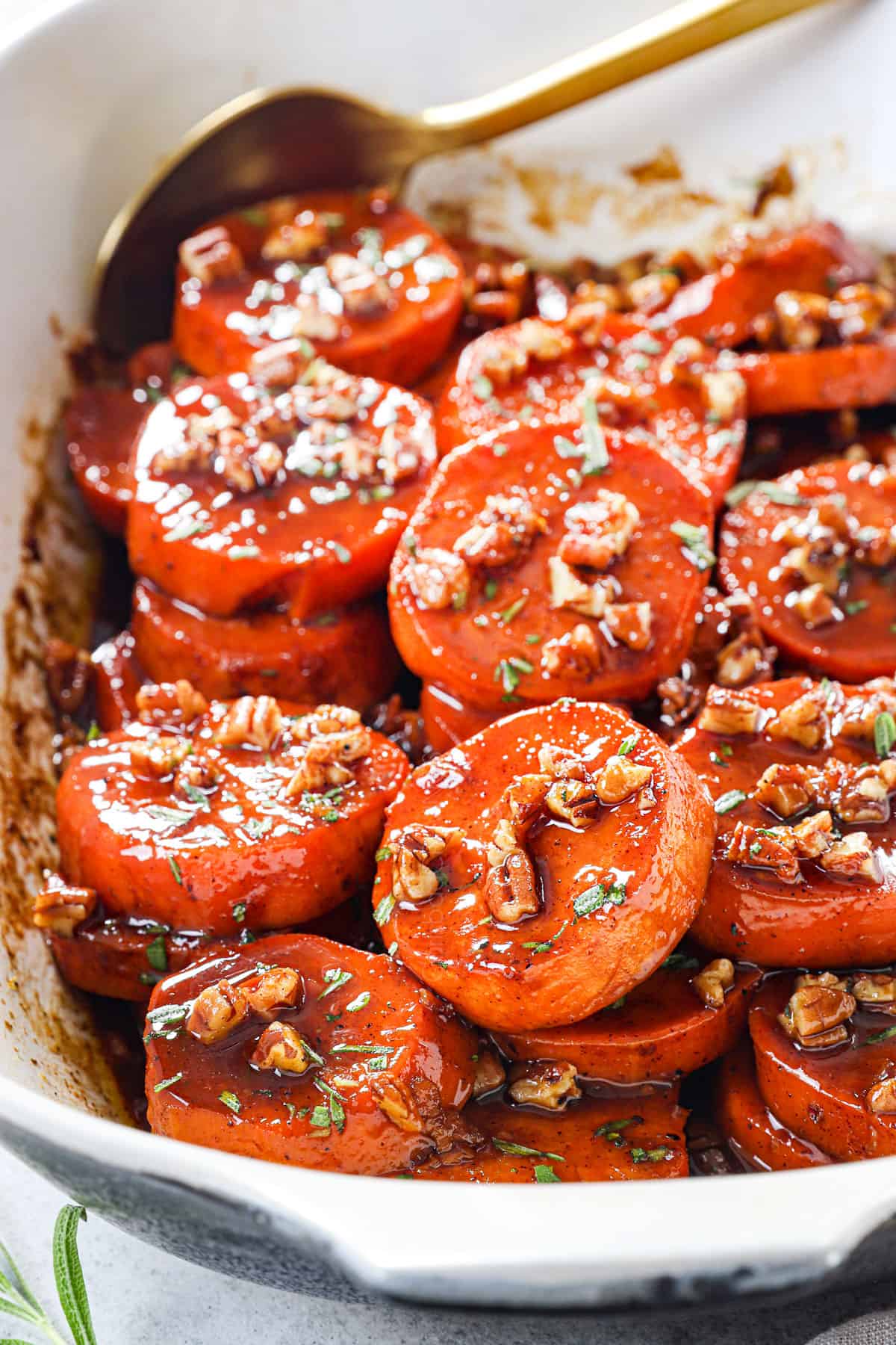 showing how to make candied yams (candied sweet potatoes) by adding pecans and baking until tender
