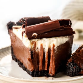 up close view of chocolate cream pie recipe with a bite taken out showing how creamy it is