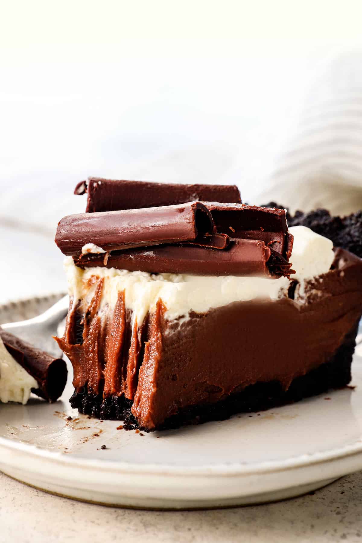 chocolate cream pie recipe with a bite taken out showing how creamy the pie is