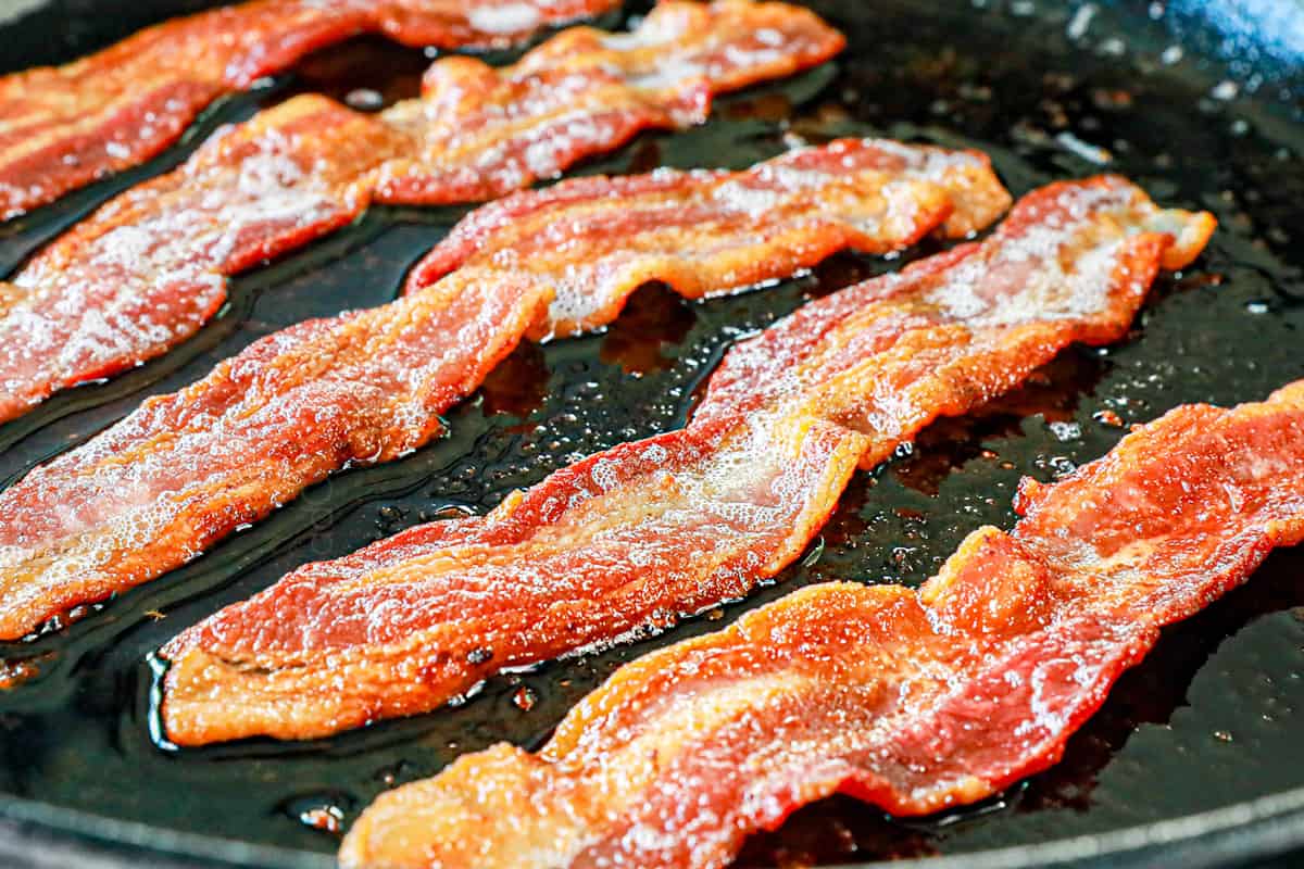 showing how to make Green Beans Almondine by cooking bacon in a skillet