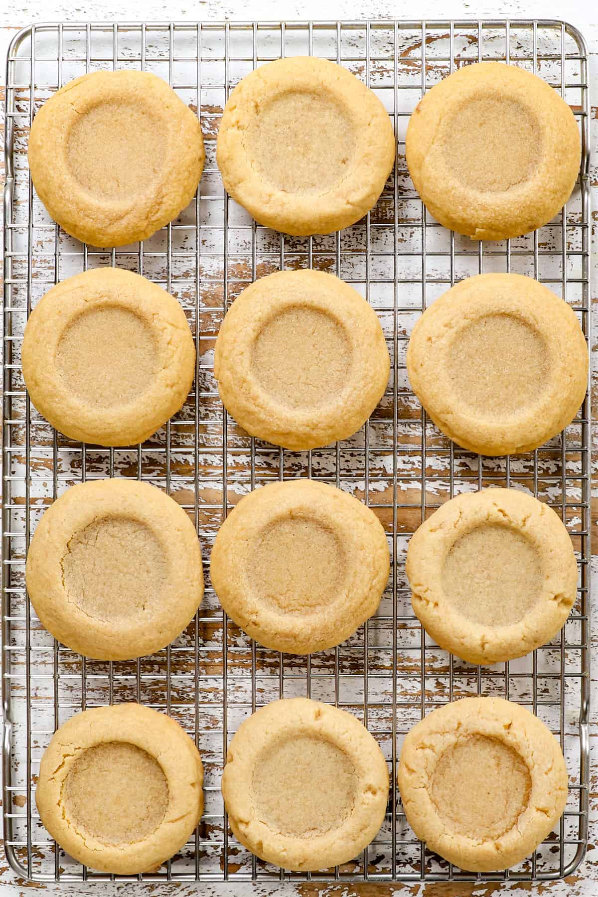 showing how to make pecan pie cookies by cooling the cookies before filling with pecan pie filling