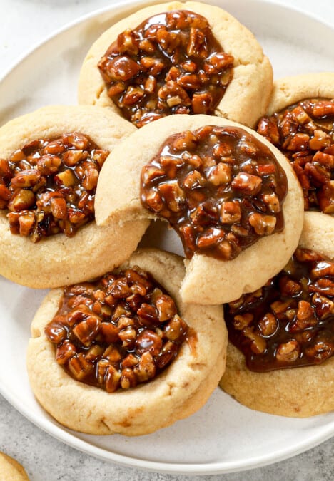 serving pecan pie thumbprint cookies on a white platter