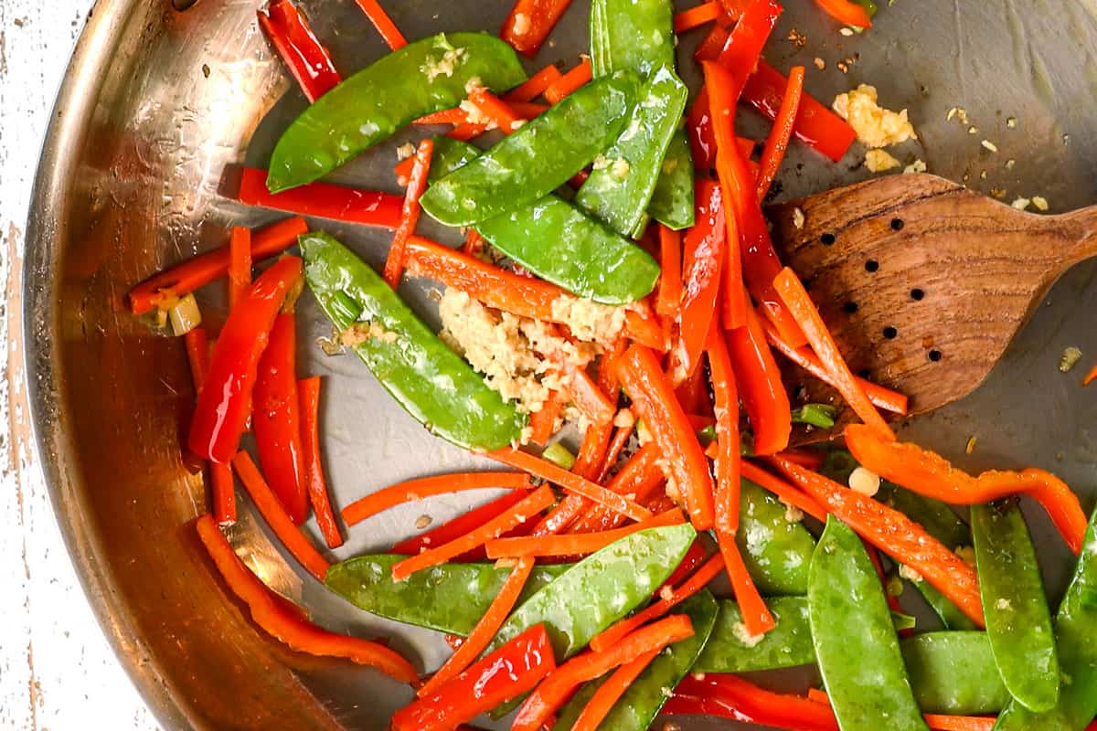 showing how to make Asian meatballs by stir frying vegetables