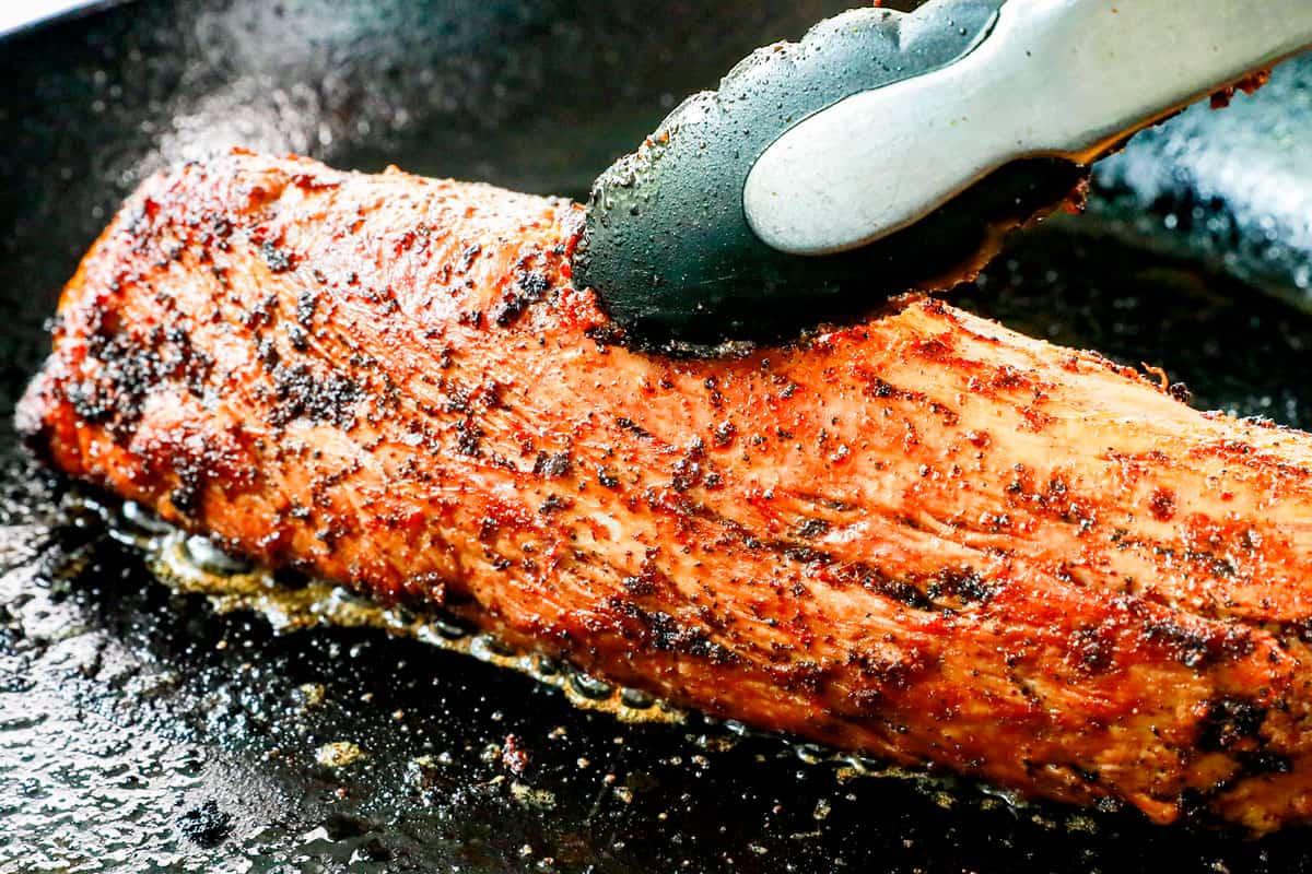 showing how to make bacon wrapped pork tenderloin by searing pork