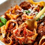 up close of twirling beef ragu with pappardelle on fork