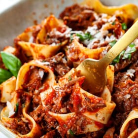 up close of twirling beef ragu with pappardelle on fork