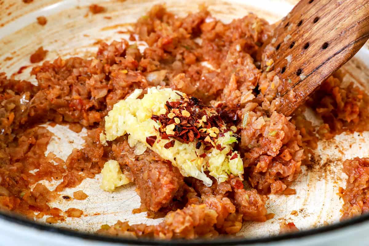 showing how to make beef ragu recipe by sautéing the onions, carrots and celery with garlic and red pepper flakes