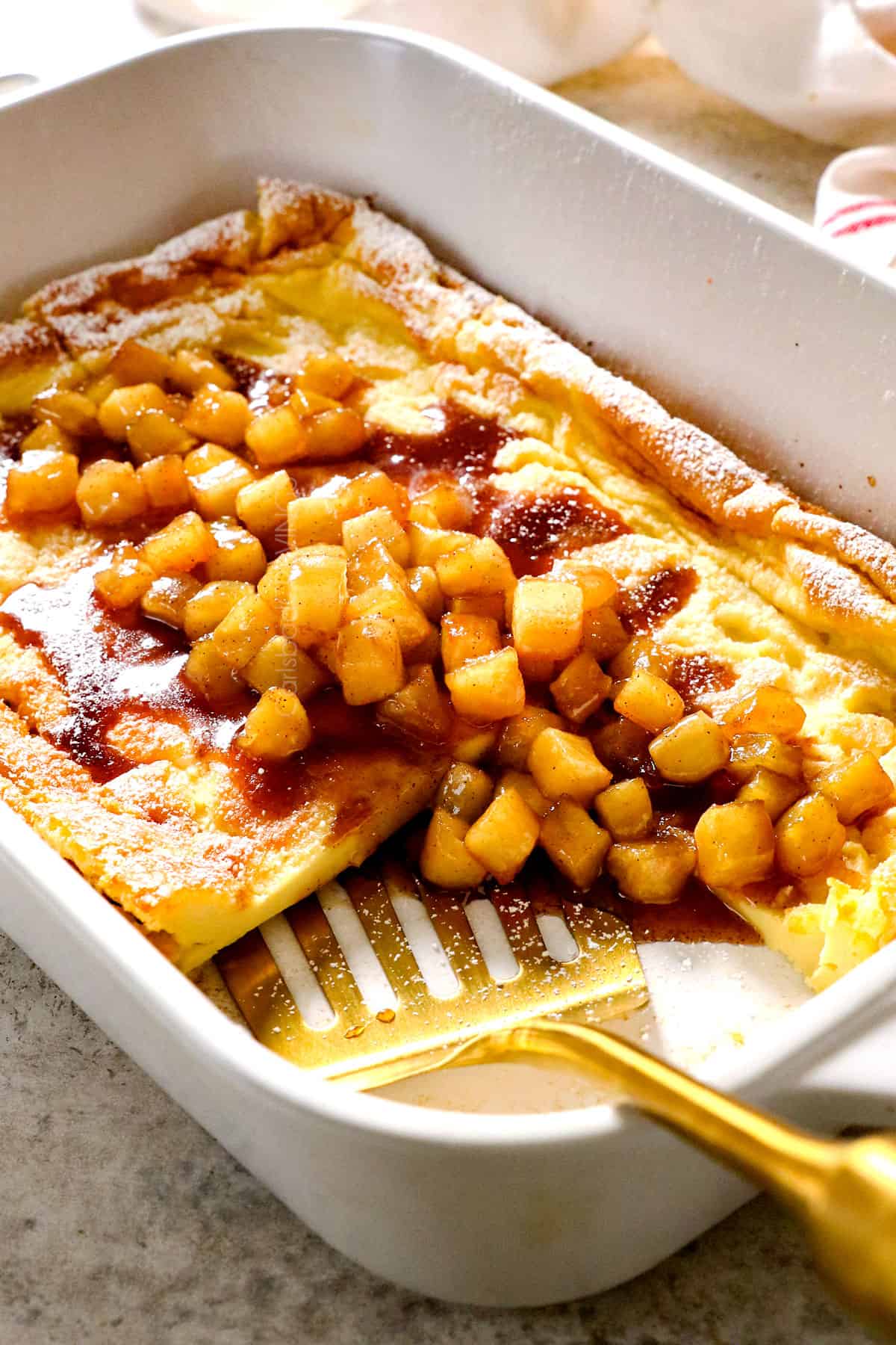 showing how to serve German pancakes recipe by slicing into pieces